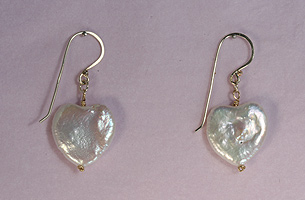 Beautiful, heart shaped freshwater cultured pearls threaded on to hand-made 9ct gold ear wires.