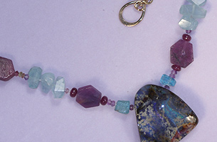 Interesting Australian boulder opal with 9ct gold clasp, mounted on a pretty necklet of semi-precious  stones, with hexagonal corundum, sparkling aquamarine, small rubies and tiny spinels.