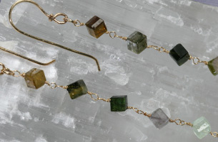 Beautiful  ear-rings in hallmarked 9ct . gold , set with cubes of colourful tourmaline, with a drop of approximately 7cm. in length from the hooks .