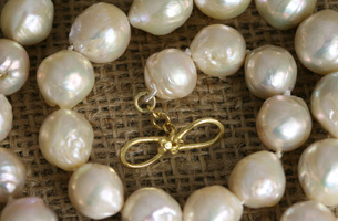 Necklace of beautifully large, baroque-shaped , freshwater cultured  pearls , set on an 18carat, hand-made , gold clasp.